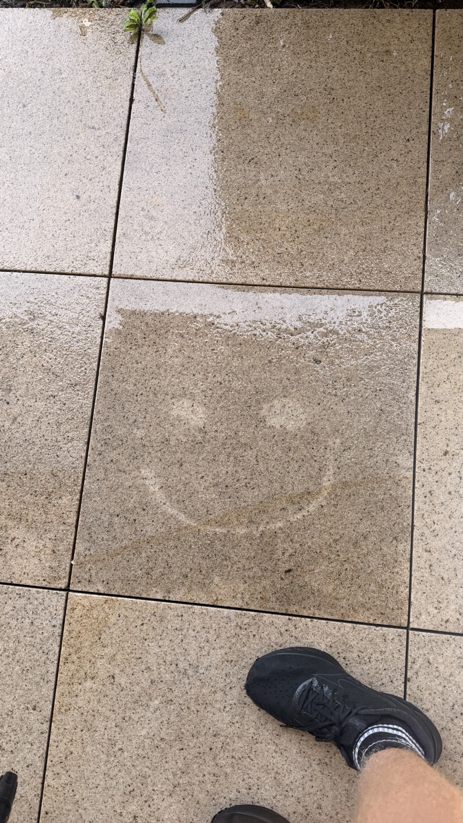 Concrete paver half cleaned showing transformation