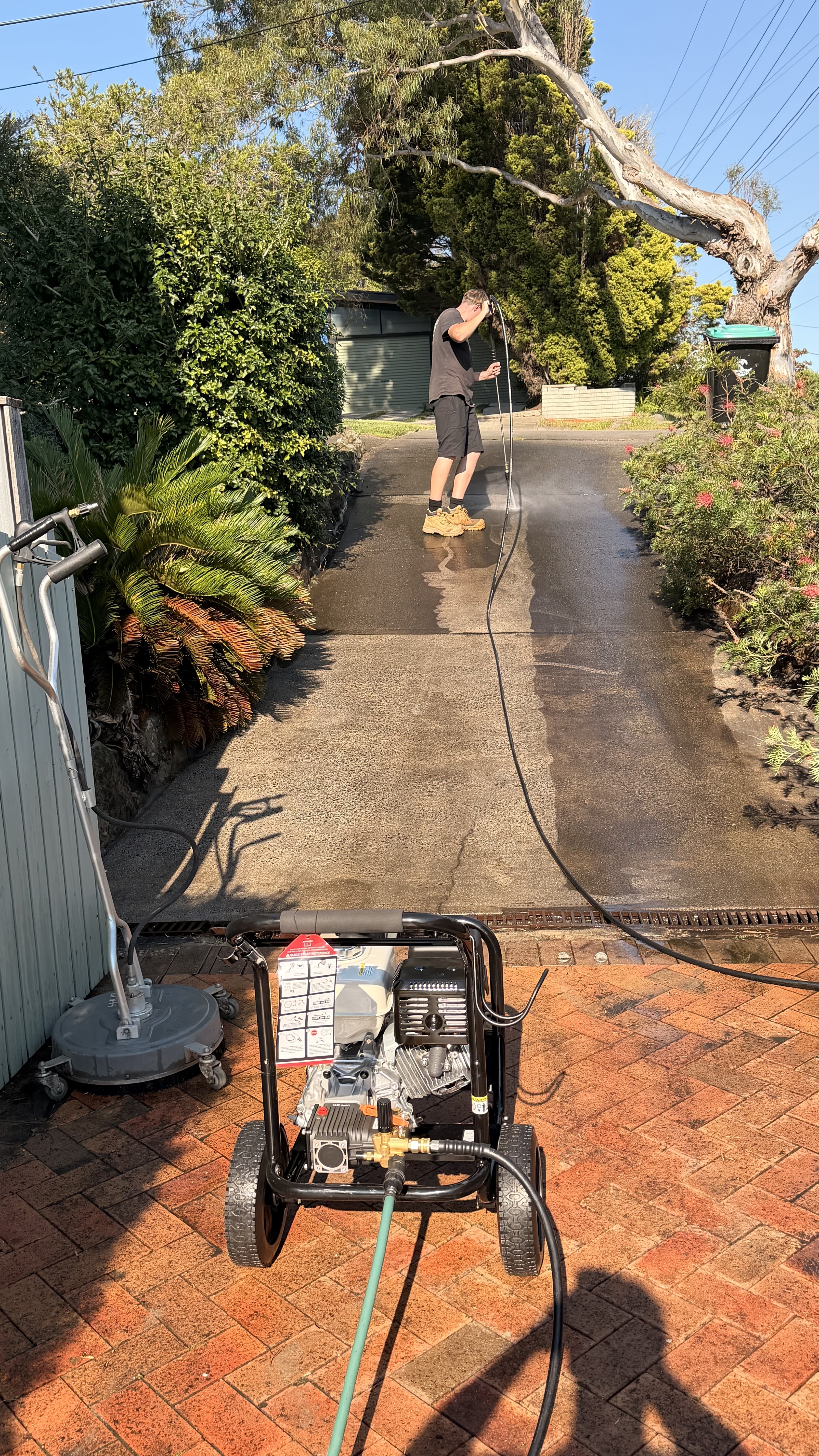 Pressure washing a driveway in Forestville with commercial equipment