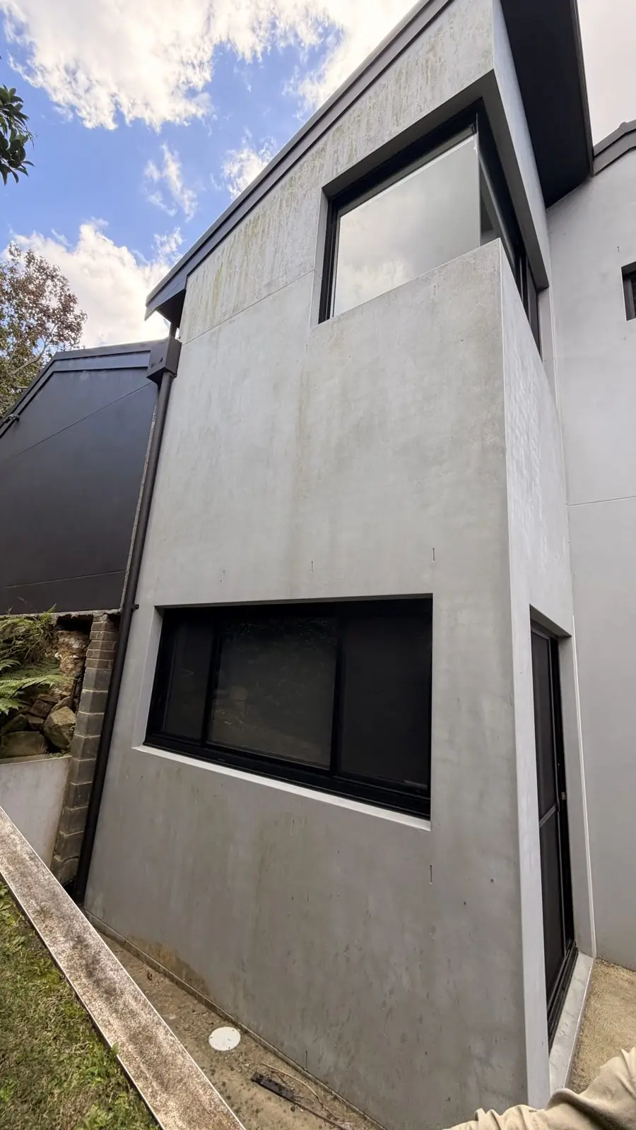 Rendered house wall shaded with mould before soft washing
