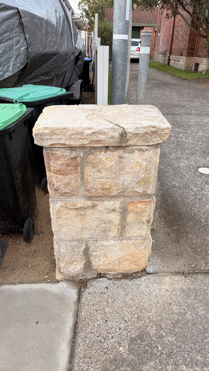 Sandstone pillar restored to natural warm colour after cleaning