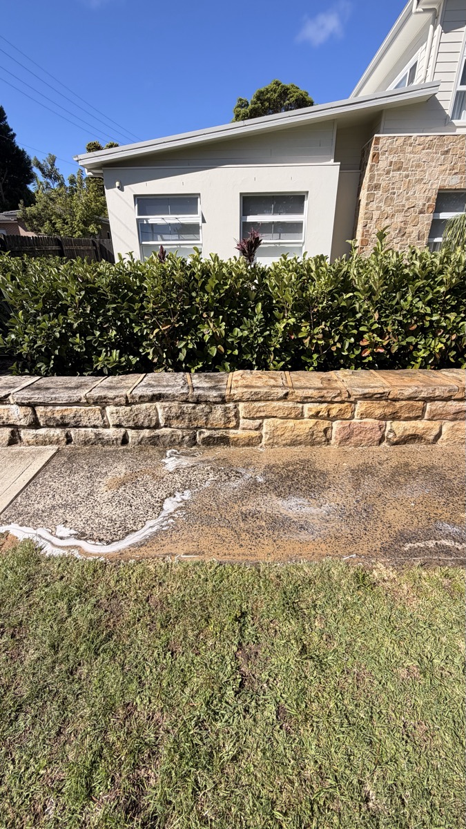 Wide sandstone retaining wall after professional cleaning